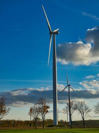 Windmill on field against sky