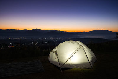 Scenic view of tent against sky during sunset