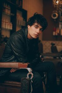 Portrait of young man sitting outdoors