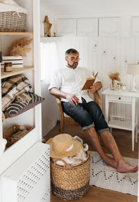 Men reading book in trailer, while traveling by camper motor home