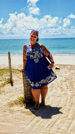 Full length of woman standing on beach