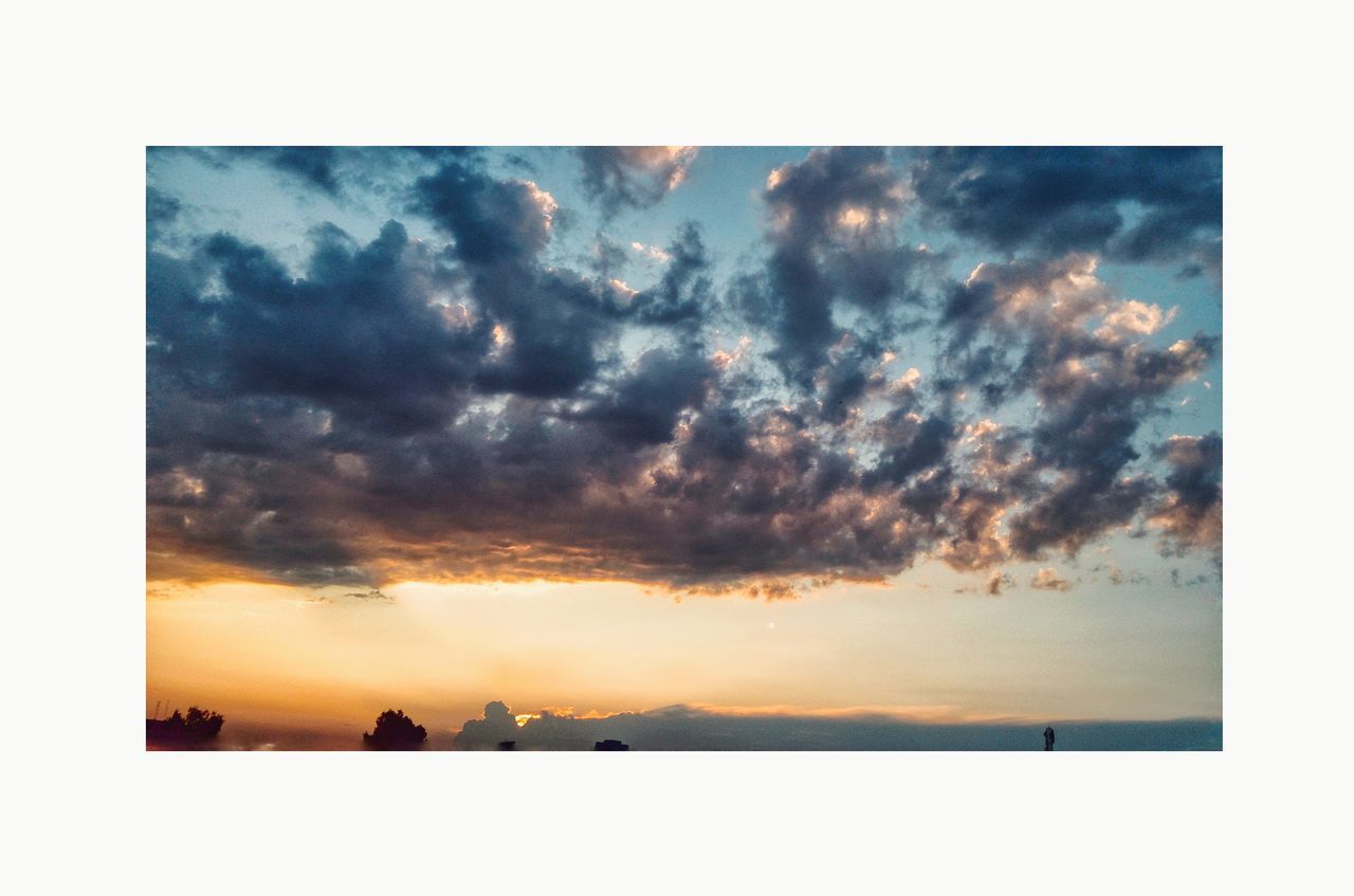 cloud - sky, sky, beauty in nature, sunset, tranquil scene, nature, tranquility, auto post production filter, transfer print, scenics - nature, no people, silhouette, outdoors, cloudscape, environment, horizon, tree, dramatic sky, landscape