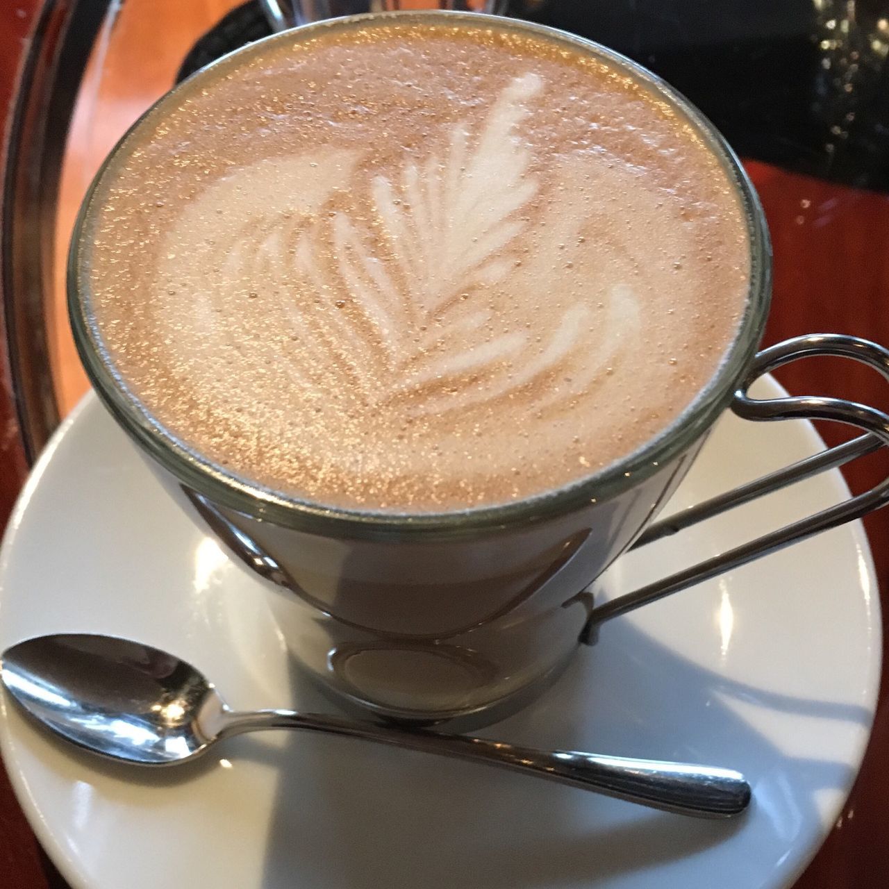 food and drink, drink, coffee cup, refreshment, freshness, coffee - drink, frothy drink, indoors, saucer, cappuccino, coffee, froth art, spoon, table, still life, close-up, cup, beverage, latte, high angle view