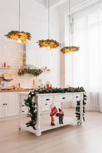 Light kitchen interior with christmas decor and white wood. kitchen in classic or scandinavian