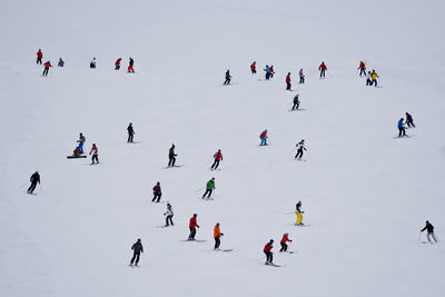 High angle view of people skiing on snow during winter