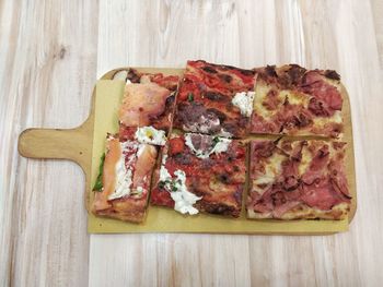 High angle view of pizza on cutting board
