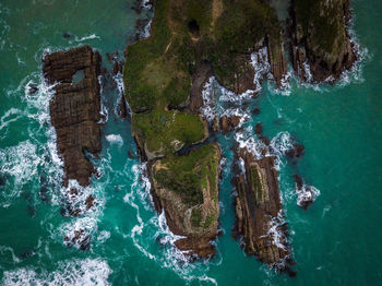 High angle view of rocks by sea