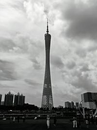 Low angle view of skyscrapers against cloudy sky