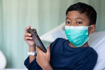 Portrait of boy holding camera