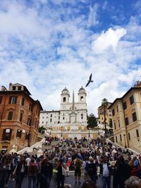 People in town square against sky