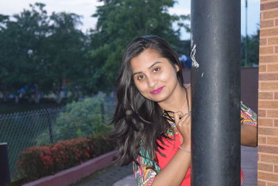 Portrait of smiling woman standing outdoors