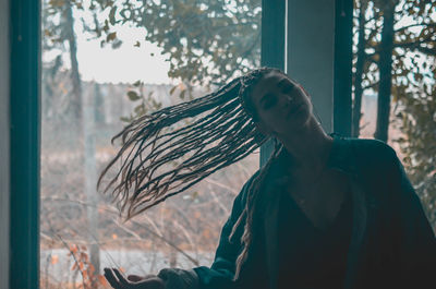 Woman standing by window