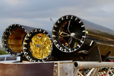 Close-up of old wheel against sky