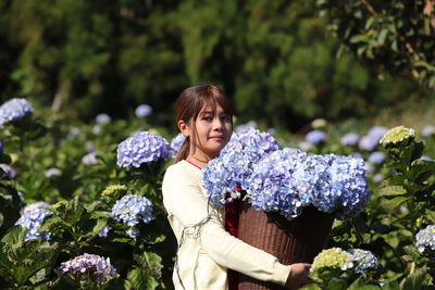 Young woman on purple flowering plants
