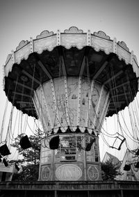 Low angle view of carousel against clear sky