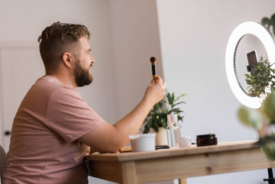 Side view of man working at home