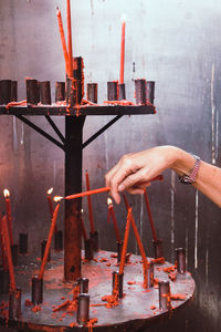 Hand holding candles on temple