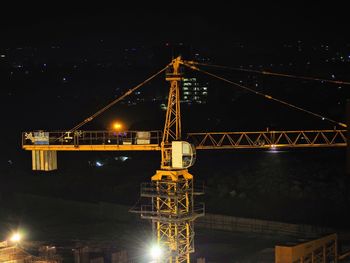 Low angle view of illuminated bridge against sky at night