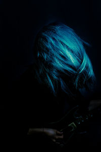 Portrait of man wearing mask against black background