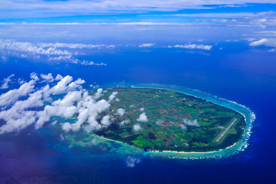 Aerial view of sea and cityscape against sky