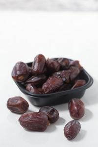 Close-up of fruits on table against white background