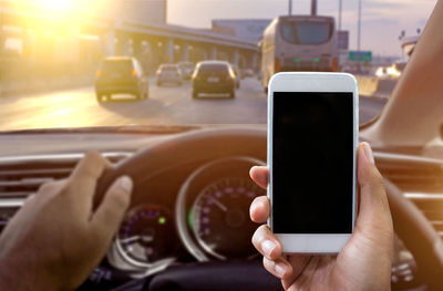 Midsection of man using mobile phone in bus
