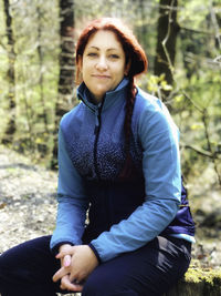 Portrait of woman sitting on land