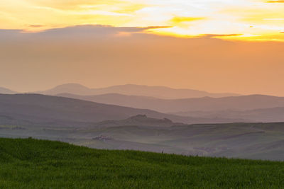 View of a rolling landscape at sunset