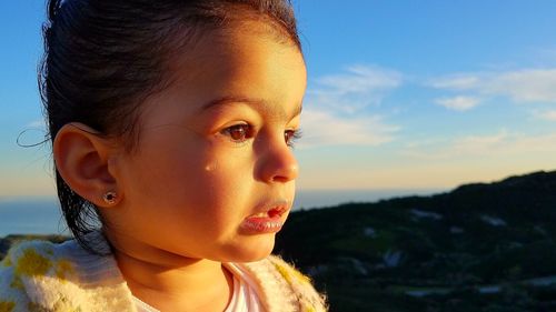 Close-up of boy against sky