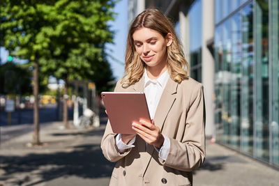 Young businesswoman using digital tablet