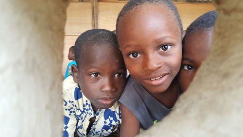 Close-up of boys seen through hole