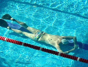 Low section of woman swimming in pool