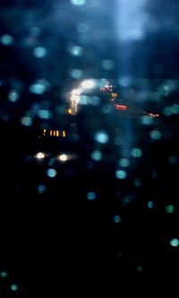 Defocused image of illuminated city at night