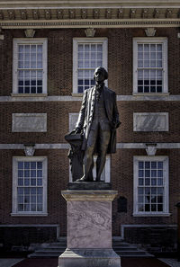 Low angle view of statue against building