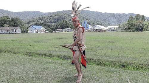 Full length of woman standing on field