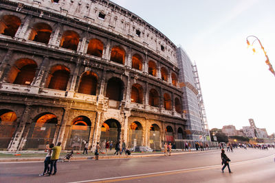 People walking in front of historical building