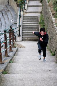 High angle view of woman running on staircase