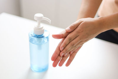 Close-up of woman holding glass bottle