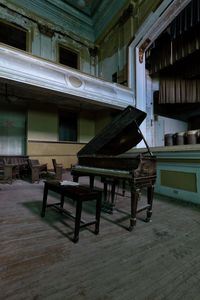 Empty chairs and table in abandoned room