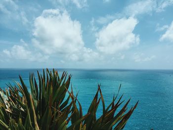 Scenic view of calm sea against cloudy sky