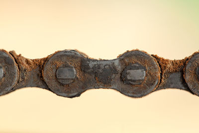 Close-up of rusty chain against clear sky