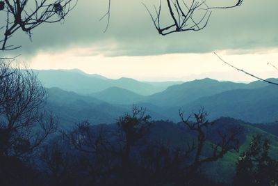 Scenic view of mountains against cloudy sky