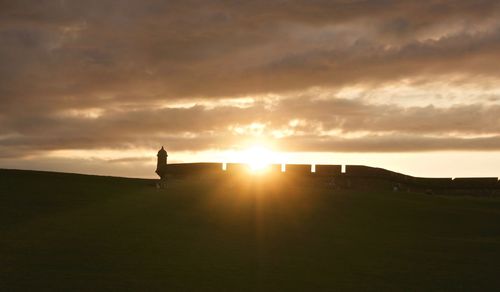 Silhouette of building against sky during sunset