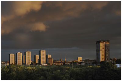 Modern buildings in city against sky