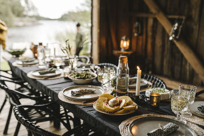 Food in plate by drinking glass arranged on table during social event