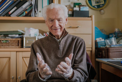 Portrait of smiling man sitting at home