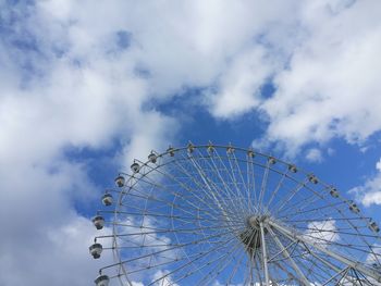 Low angle view of ferris wheel against blue sky