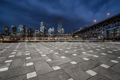 View of city street and bridge against sky