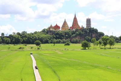 Panoramic view of temple on field against sky