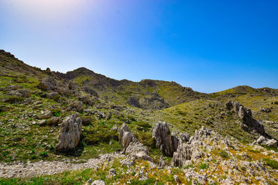 Scenic view of rocky mountains against clear blue sky